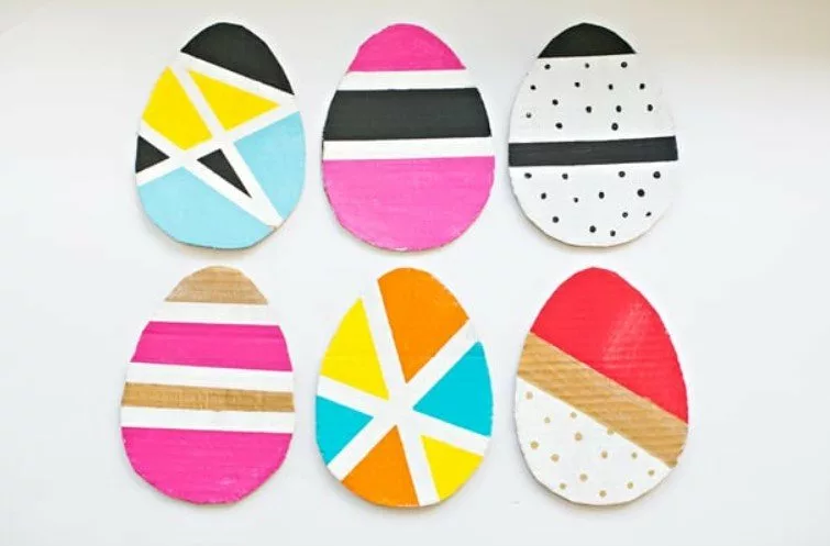 An image of 6 easter eggs cut out of cardboard. They have been painted in various colours and designs.